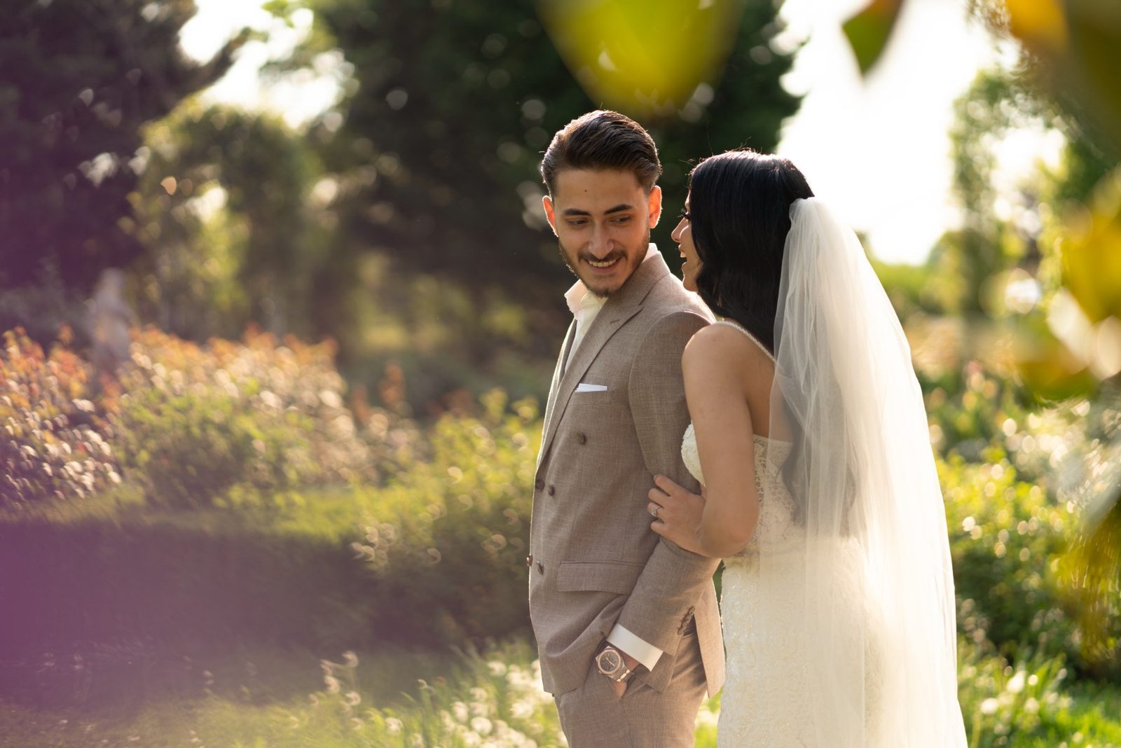 Newlyweds embracing in an outdoor garden